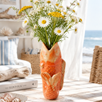 An orange and beige glazed ceramic fish-shaped planter with a textured scale pattern, photographed on a clean white background.